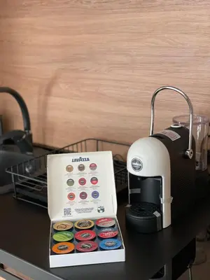 a box of donuts sitting next to a coffee maker at Blue berry apart in Budva