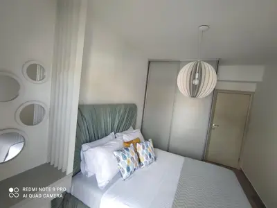 a small bedroom with a bed with two pillows at Blue berry apart in Budva