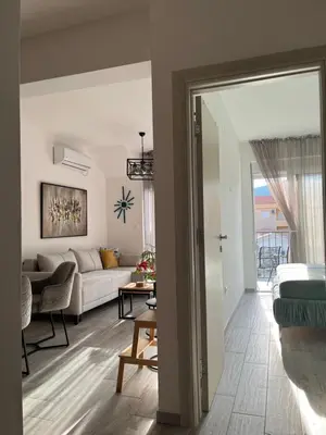 a living room with a couch and a table at Blue berry apart in Budva