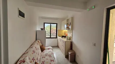 a small room with a bed and a refrigerator at Apartments Val Maslina in Utjeha