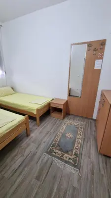 a room with two beds and a chalkboard in it at Apartments Val Maslina in Utjeha