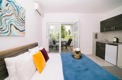 a living room with a bed and a kitchen at Apartments Lungo Mare Ulcinj in Ulcinj