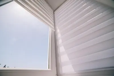 a window with white blinds in a room at Apartments Lungo Mare Ulcinj in Ulcinj