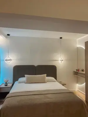 a bedroom with a bed with two lights above it at Casa Nita in Ulcinj