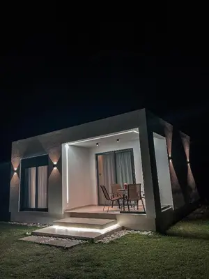 a small house with a patio at night at Casa Nita in Ulcinj