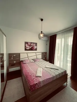 a bedroom with a bed with a pink bedspread at Casa Nita in Ulcinj