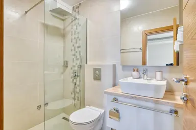 a bathroom with a toilet and a sink and a shower at SYMPHONY in Petrovac na Moru
