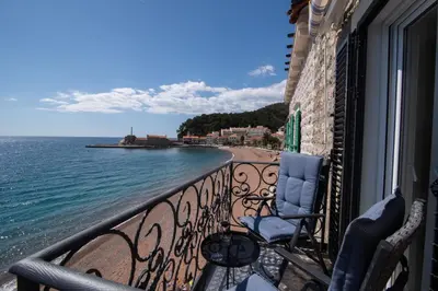 a balcony with chairs and a view of the ocean at SYMPHONY in Petrovac na Moru