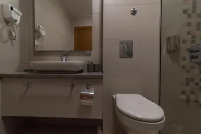 a bathroom with a toilet and a sink at SYMPHONY in Petrovac na Moru