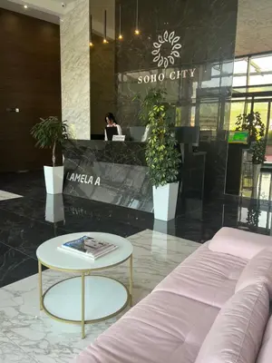 a room with a couch and a table and a person at EmZa Sea View Apartment in Bar