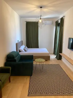 a living room with a bed and a couch at EmZa Sea View Apartment in Bar