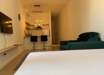a room with a bed and a living room at EmZa Sea View Apartment in Bar