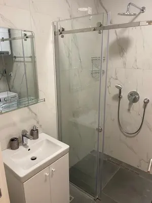 a bathroom with a shower and a sink at EmZa Sea View Apartment in Bar