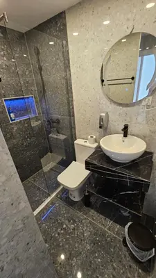 a bathroom with a sink and a toilet and a mirror at Villa Alba Apartments in Dobra Voda