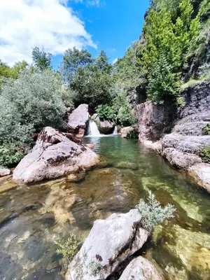 a river with rocks and a waterfall at Riverside in Virpazar