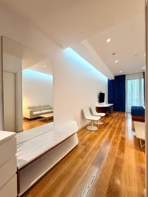 a living room with a bed and a desk at Condo Studio Plaza in Budva