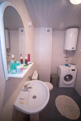 a bathroom with a sink and a washing machine at Apartment Plamenatz in Bar