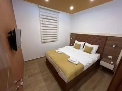 a bedroom with a bed with two towels on it at Heaven Lux Ulcinj in Ulcinj