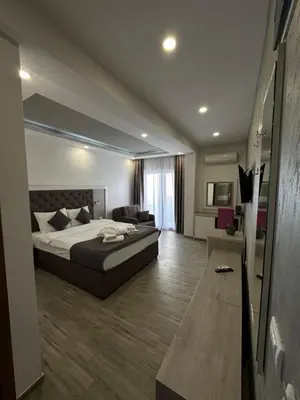 a large bedroom with a bed and a couch at Heaven Lux Ulcinj in Ulcinj