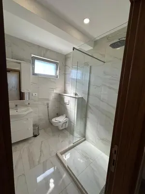 a bathroom with a toilet and a glass shower at Heaven Lux Ulcinj in Ulcinj
