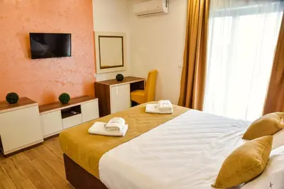 a hotel room with two beds and a television at Heaven Lux Ulcinj in Ulcinj