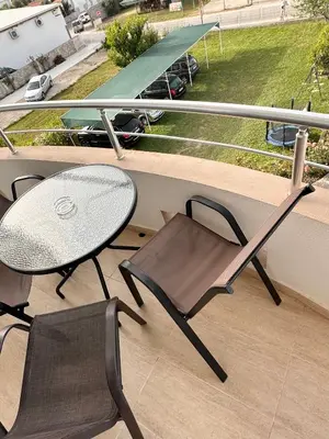 a balcony with a table and two chairs and a table at Apartmens Xhenis Lux in Ulcinj
