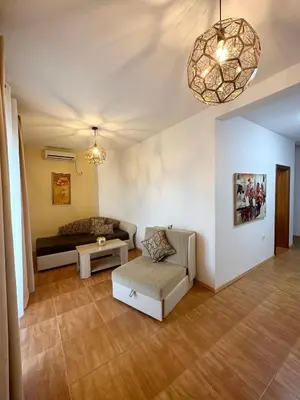 a living room with a couch and a table at Apartmens Xhenis Lux in Ulcinj