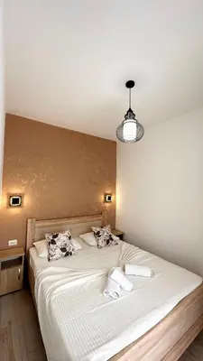 a bedroom with a bed with two towels on it at Apartmens Xhenis Lux in Ulcinj