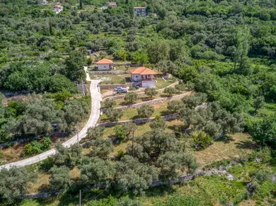 an aerial view of a house on a hill with trees at Two Bedroom House with Sea View MAJ in Ðurovići