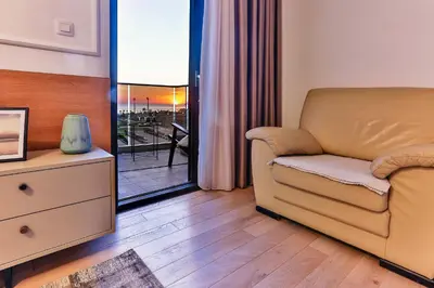 a living room with a couch and a balcony at A21 LUX - Soho City Complex in Bar