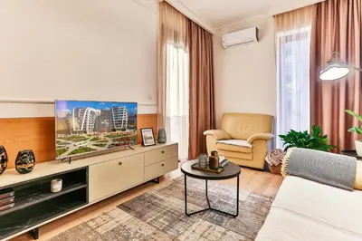 a living room with a tv and a couch and a table at A21 LUX - Soho City Complex in Bar