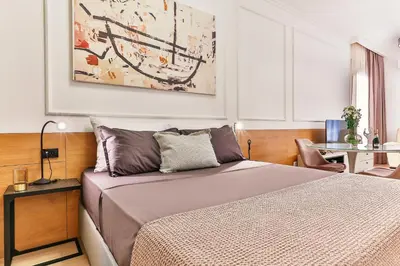 a small bedroom with a bed and a table at A21 LUX - Soho City Complex in Bar