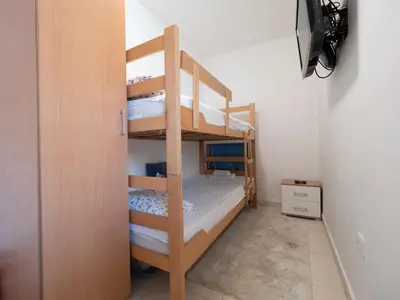 a bunk bed room with two bunk beds at Sea view Two bedroom Family Apartment with pool - Sunset Ivanovići in Becici