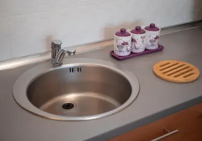 a kitchen counter with a sink and two cups at Sea view Two bedroom Family Apartment with pool - Sunset Ivanovići in Becici