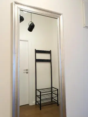a mirror in a room next to a door at Downtown apartment in Cetinje