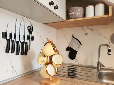 a kitchen with a bunch of utensils on the wall at Downtown apartment in Cetinje