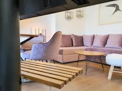 a living room with a couch and a table at Downtown apartment in Cetinje
