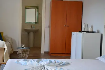 a room with a white refrigerator and a sink at NEXT DOOR HOUSE in Ulcinj