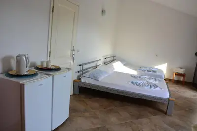 a bedroom with a bed and a table with a counter at NEXT DOOR HOUSE in Ulcinj