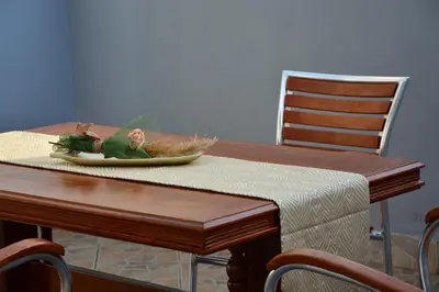 a wooden table with a plate of food on it at NEXT DOOR HOUSE in Ulcinj