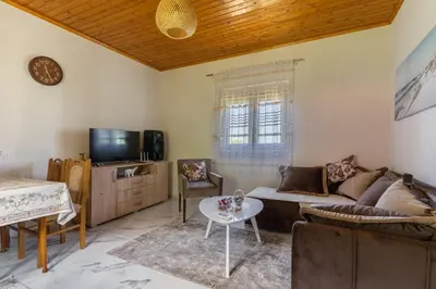 a living room with a couch and a table at AparDibra in Bar