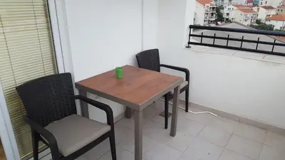 a small table and chairs on a balcony at Sea View Studio in Becici