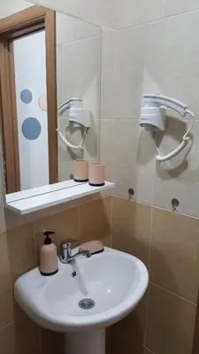 a bathroom with a sink and a mirror at Sea View Studio in Becici