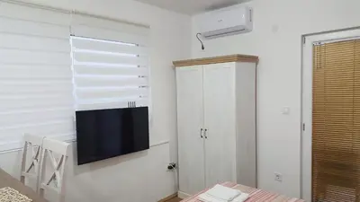a living room with a tv on a wall at Sea View Studio in Becici