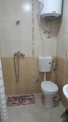 a bathroom with a toilet and a shower and a sink at Sea View Studio in Becici