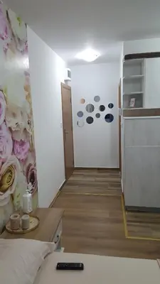 a room with a wall with flowers on it at Sea View Studio in Becici