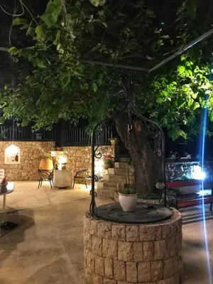 a large tree in a room with a brick wall at Oldmill Apartment in Ulcinj