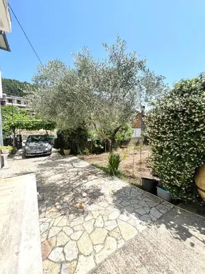 a driveway with a car parked in a yard at Oldmill Apartment in Ulcinj
