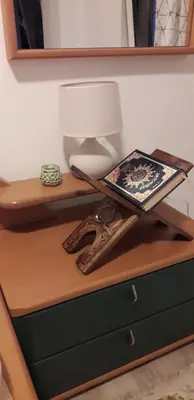 a table with a lamp and a book on it at Oldmill Apartment in Ulcinj