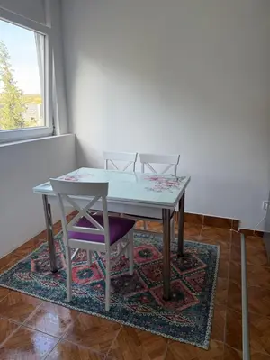a table and two chairs on a rug in a room at Podgorica Great location in Podgorica